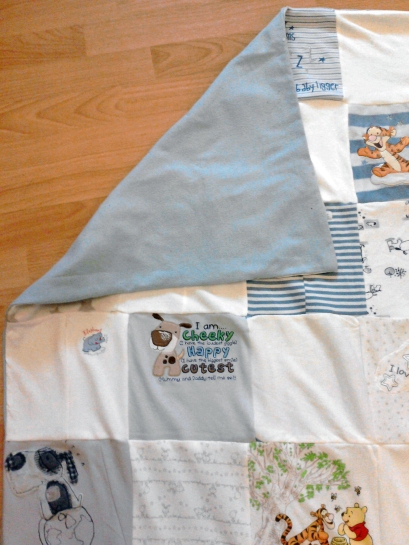 A photo of the finished blanket with the blue lining showing